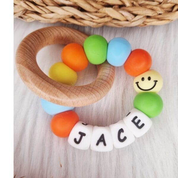 Bijtring met naam Smiley babyblauw
